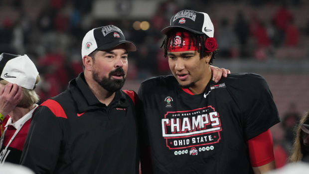 Jan 1, 2022; Pasadena, CA, USA; Ohio State Buckeyes head coach Ryan Day and quarterback C.J. Stroud (7) celebrate on the podium after the win against the Utah Utes during the 2022 Rose Bowl college football game at the Rose Bowl.